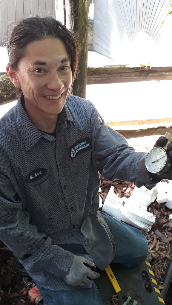Plumber checking water pressure during a diagnostic visit